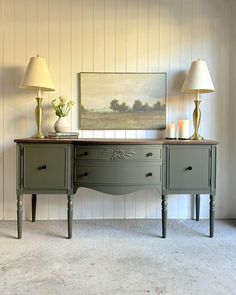 two lamps are sitting on top of an old desk in the corner of a room