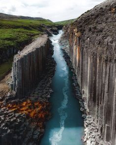 an image of a river in the middle of some rocks with water flowing between them