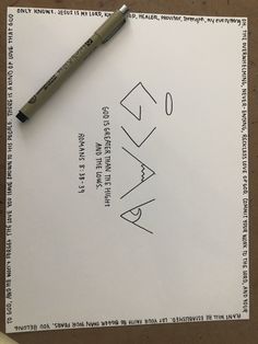 a pen sitting on top of a piece of paper next to an envelope with the word okay written in it