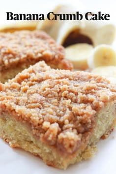 two pieces of banana crumb cake sitting on top of a white plate next to sliced bananas