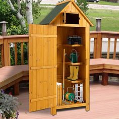 a wooden shed with its doors open and gardening tools in the bottom shelf next to it