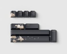 two black shelves with flowers on them and one shelf has five different types of keys