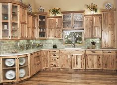 a kitchen with wooden cabinets and green tile backsplash