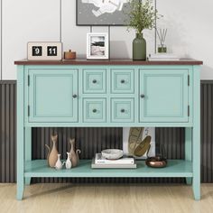 a blue cabinet with drawers and vases on top