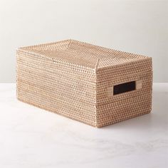 an empty wicker box on a white surface