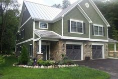 a large house with two garages in the front and one on the other side