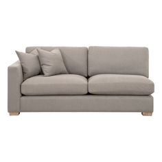 a gray couch with two pillows on the back and one pillow sitting on top of it