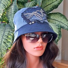 "The '90s are back! I hand make these hats by upcycling denim fabric sourced from various denim garments and lining it with satin for comfort and to protect your hairstyle.   All garments are thoroughly washed and steamed.  All my products made in pets and smoke-free free environment.  Size:S,M Hat size is 22.5 inches/57cm , 3.75 inches /9.5 in height, and 2.5 inches /6 cm wide brim.   Mannequin head size is 21\" around.  This hat would make a perfect accessory and a wonderful gift. Washing instructions: Dry clean only! Safe to iron. 100% upcycled handmade denim hats ready to ship." One Size Fits Most Denim Hat In Denim Blue, One Size Fits Most Denim Blue Hat, Denim Blue Short Brim Hats, Denim Blue Short Brim Denim Hats, Denim Bucket Hat In Medium Wash, Denim Visor Hat One Size, Denim Blue Denim Hat For Streetwear, Blue Denim Hat For Streetwear, Bucket Hats Denim