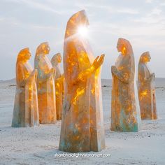 the sun shines brightly on statues in the desert