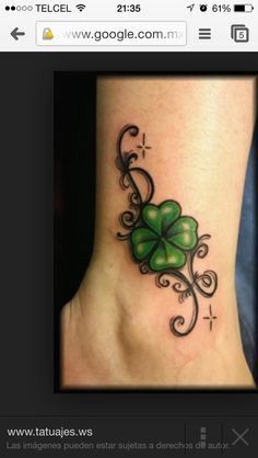 the foot tattoo has four leaf clovers on it's side, and is decorated with