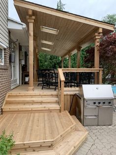 a covered patio with grill and hot tub