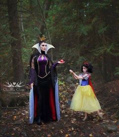 two women dressed as snow white and evil queen in the woods