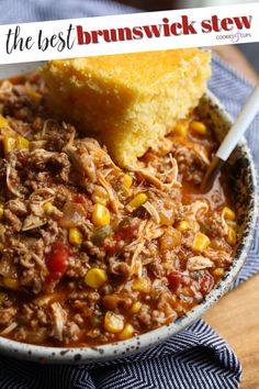 a bowl filled with chili and corn next to a piece of bread