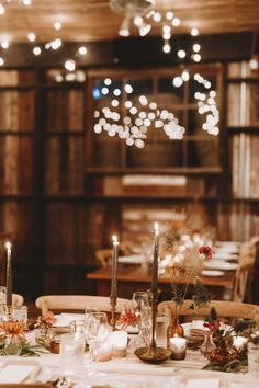 the table is set with candles and place settings