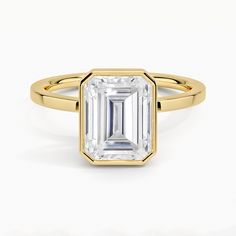 an emerald - cut diamond ring on a white background