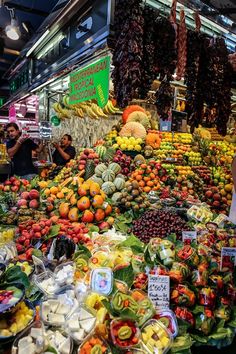 an outdoor market with lots of fruits and vegetables