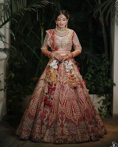 a woman in a red and gold bridal gown