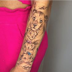 a woman with a lion and cubs tattoo on her arm, both showing their faces