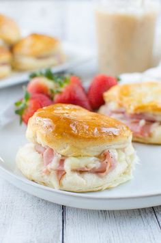 ham and cheese biscuits on a plate with strawberries