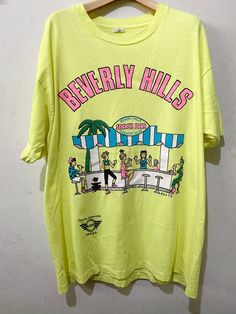 "Vintage 90s Beverly Hills Shirt Size: XL Made In USA Measurements are taken with the garment laying flat. Chest width: 23\" Body Length : 29.5\" Condition: Pre-owned 8/10 Material: 100% Cotton Comment Stain like pic No refund. -Payment : accept paypal only -Shipping : to shipping worldwide by registered airmail (small package) Thai post registered. receiving the item within 7-30 business days non sat-sunday working after payment cleared  (some case in Australia/italy/spain/north and south america 2-4 weeks) I ship every day, monday through Friday! Many times your item will go out same day!! Get your stuff super fast when you buy from me! -Check item status out of my country: http://track.thailandpost.co.th 11C" 90s Graphic Tees Vintage, 90s Beverly Hills, Vintage Beverly Hills, Comfy Fall Sweaters, Genderqueer Fashion, Official Dresses, Patagonia Shirts, Jeans Shirt, North And South America