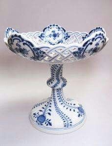 a blue and white bowl sitting on top of a table