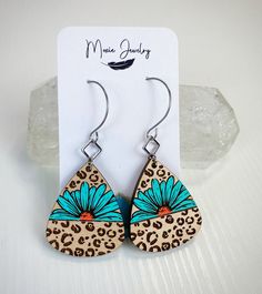 These turquoise wood earrings feature a Daisy surrounded by leopard print. So stinkin' cute! They feature rhodium accents and stainless steel earwires. They measure approximately 2.5" long and are extremely lightweight. They are hand painted and handmade. Handmade Leopard Print Earrings, Trendy Leopard Print Earrings As Gift, Leopard Print Drop Earrings Gift, Adjustable Leopard Print Earrings For Gift, Leopard Print Earrings For Gift, Leopard Print Earrings For Pierced Ears As Gift, Hand Painted Earrings Wood, Diy Earrings Polymer Clay, Hand Painted Earrings