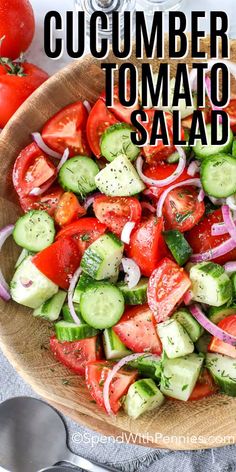 a wooden bowl filled with cucumber tomato salad