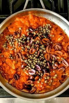 a pan filled with food sitting on top of a stove