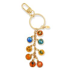 a key chain with charms hanging from it's side on a white background,