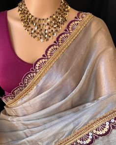 Silver mettalic tissue saree with contrast magenta golden lace all over sarees. Comes with beautiful big magenta thread tassels on pallu. Blouse: running blouse 80cm. To find this product in website: Www.thejacouture > Tissue sarees> silver mettalic tissue saree. Jewellery collaboration: @anvi__jewellery #mettalictissuesaree #silversaree #fancysaree #tissuesaree #trendingsaree #tissuelacesaree Magenta Saree Contrast Blouse, Silver Blouse Designs, Silver Tissue Saree, Latest Blouse Neck Designs