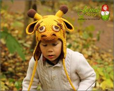 a little boy wearing a knitted animal hat