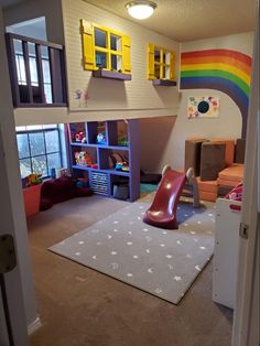 a child's playroom with a slide, bookshelf and toys in it