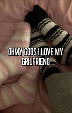 someone is laying in bed with their feet up on the covers and socks that say, ohmy god i love my girlfriend