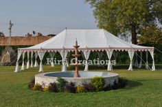 a large white tent set up in the middle of a field