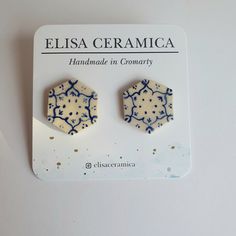 Hand made and delicately painted ceramic stud earrings, these are blue and white small earrings, good for someone who might like abstract designs.  The earrings are mounted on 925 / sterling silver studs and findings.  Each earring has approximately the following measurements:  H 28mm W 20mm D 2mm These arty earrings have been handmade with white earthenware clay. Each goes through multiple firing cycles to preserve the hand pained details.  The side which was touching the kiln is left unglazed, and then post firing covered in resin to give an extra layer of protection to the sterling silver stud.  These earrings are light and comfortable to wear. These are made with 100% sterling silver earring backs which are great for sensitive ears. Due to their handmade nature they are totally unique. Artistic White Round Earrings, White Hand Painted Artisan Earrings, White Artisan Hand-painted Earrings, Hand Painted White Earrings As A Gift, Hand Painted White Earrings For Gift, White Hand Painted Earrings For Gift, White Round Plug Earrings As A Gift, Unique White Plug Earrings As Gift, Ceramic Earrings