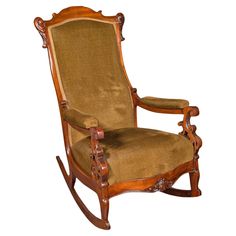 a wooden rocking chair with brown upholstered fabric on it's back and arms