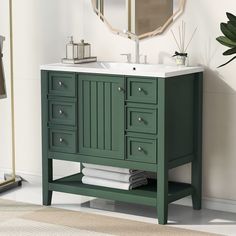 a bathroom with a sink, mirror and green cabinet