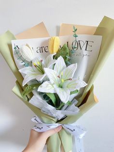 someone is holding a bouquet of flowers in front of a magazine with corn on the cob