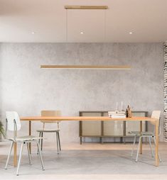 a table and chairs in a room with stone walls