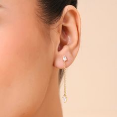 Minimalistic and chic, these threader earrings are inspired by the Arctic glow, radiating a subtle, mesmerizing light that adds enchanting allure to your ensemble. They feature pear-shaped studs adorned with shimmering crystals, delicately linked by a graceful chain that drapes around the earlobe, with a crystal stone delicately dangling. This design achieves a harmonious blend of simplicity and sophistication, evoking the pristine beauty and luminosity found in Arctic landscapes. Metal- Recycle White Teardrop Linear Earrings Dainty Style, White Threader Earrings With Adjustable Chain, White Teardrop Dainty Linear Earrings, White Dainty Teardrop Linear Earrings, Dainty White Teardrop Linear Earrings, White Teardrop Threader Earrings For Gifts, Arctic Landscape, Threader Earrings, Crystal Stone