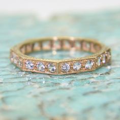 a close up of a gold ring with diamonds on it's sides and in the middle