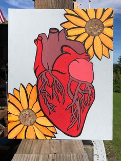 a painting of a heart and sunflowers on a white board