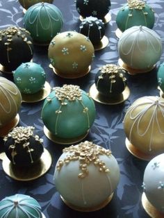 there are many decorated chocolates in the shape of flowers and pearls on top of each other