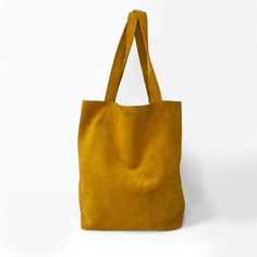 This classical tote bag made of soft suede in yellow golden colour, with two handles and one inner pocket with zipper. * Composition: 100% suede * Dimensions: Width: 30 cm (11.8 inch) Height: 38 cm (14.9 inch) Depth: 11 cm (4.3 inch) * One inner pocket with zip closure Yellow Purse, Yellow Tote Bag, Yellow Purses, Suede Tote Bag, Golden Colour, Suede Tote, Tote Bag Purse, Leather Bags Handmade, Tote Bag Leather