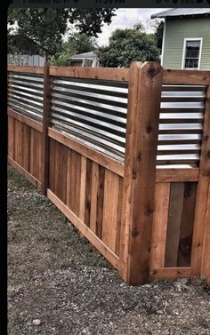 a wooden fence with metal slats on it