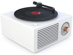 an old - fashioned record player is sitting on top of a white box with red knobs