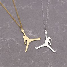 Celebrate your love for the game with this striking silver and gold Jordan necklace. Featuring a sleek design, it combines the classic elegance of silver with the bold statement of gold. Choose from a Jumpman logo, a basketball pendant, or even a Jordan's jersey number for a personalized touch. This necklace is perfect for any basketball fan or admirer of the legendary Michael Jordan. Materials: 925K Sterling Silver Style: Minimalist  Pendant Size : Height 30mm x Width 27mm Chain style: Cable Ch Jordan Necklace, Basketball Theme Room, Basketball Jewelry, Video Game Room Decor, Basketball Necklace, Minimalist Pendant, Jumpman Logo, Sports Jewelry, Basketball Gifts