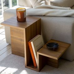 a coffee table with books and a candle on it