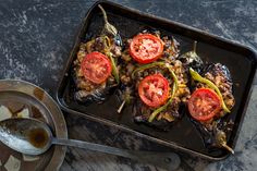 a pan filled with meat and vegetables on top of a table