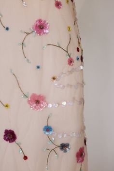 a dress with flowers and beads on it